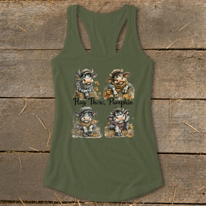 Four cartoon cows wearing scarves and hats on a tank top, with text "Hay There, Pumpkin".