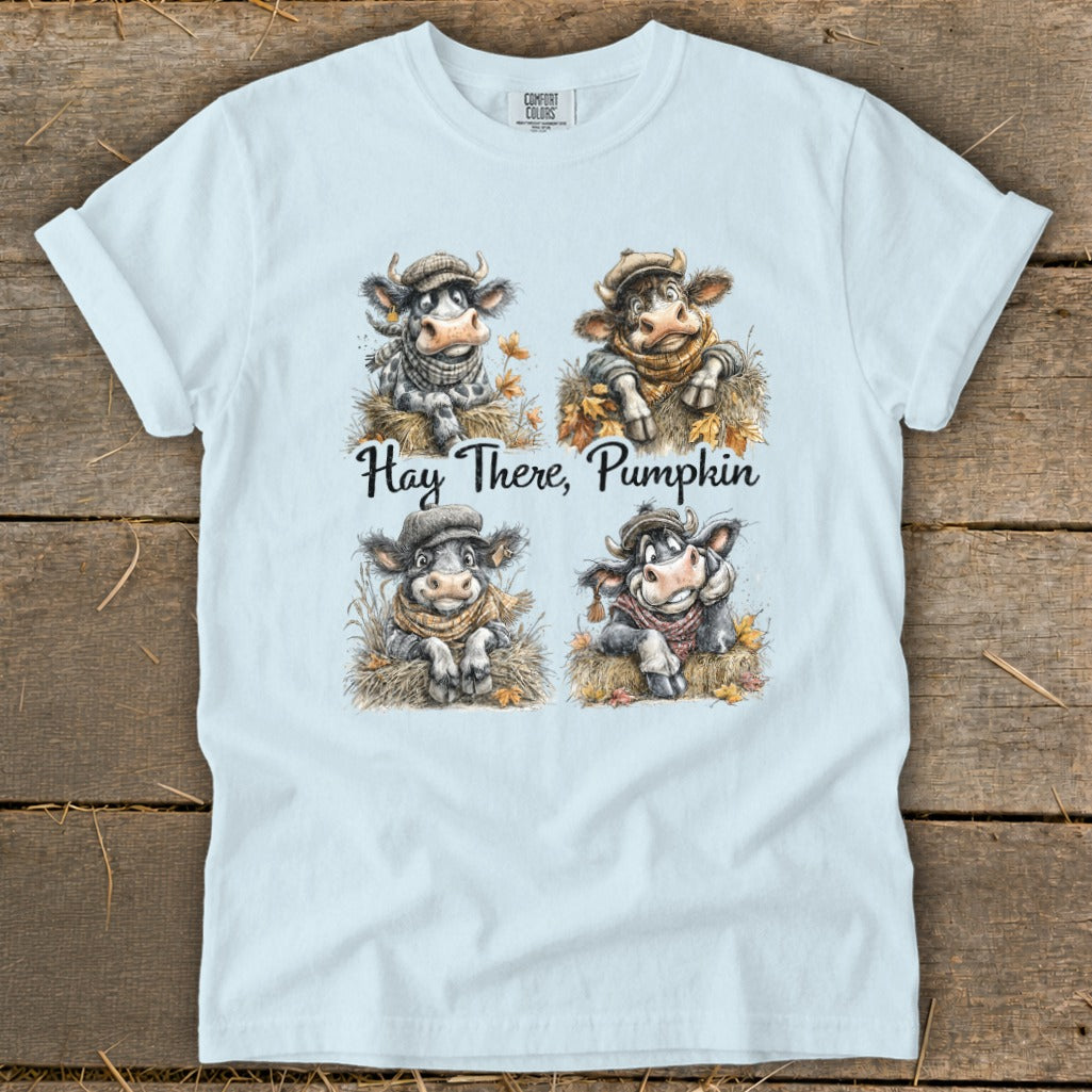 Four cartoon cows wearing scarves and hats, with text "Hay There, Pumpkin".