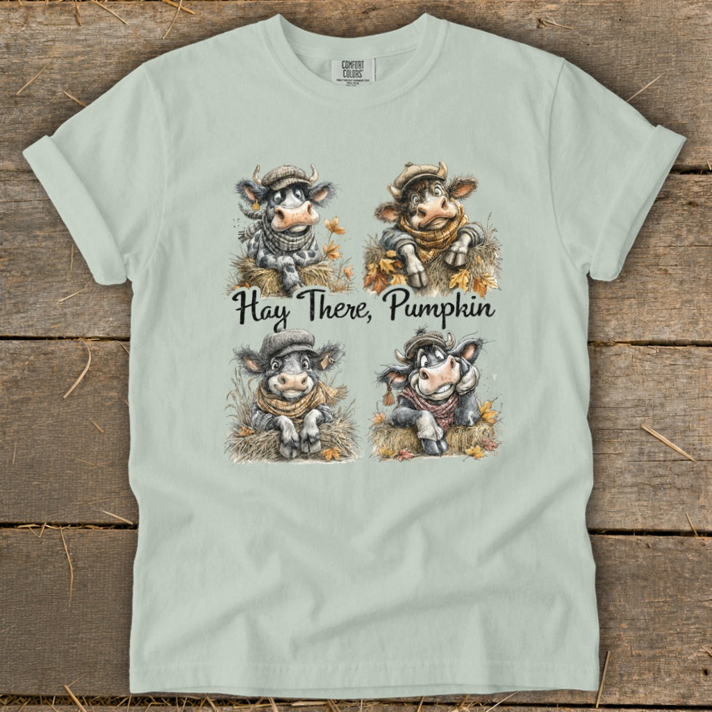 Four cows in hats and scarves are depicted with text "Hay There, Pumpkin".