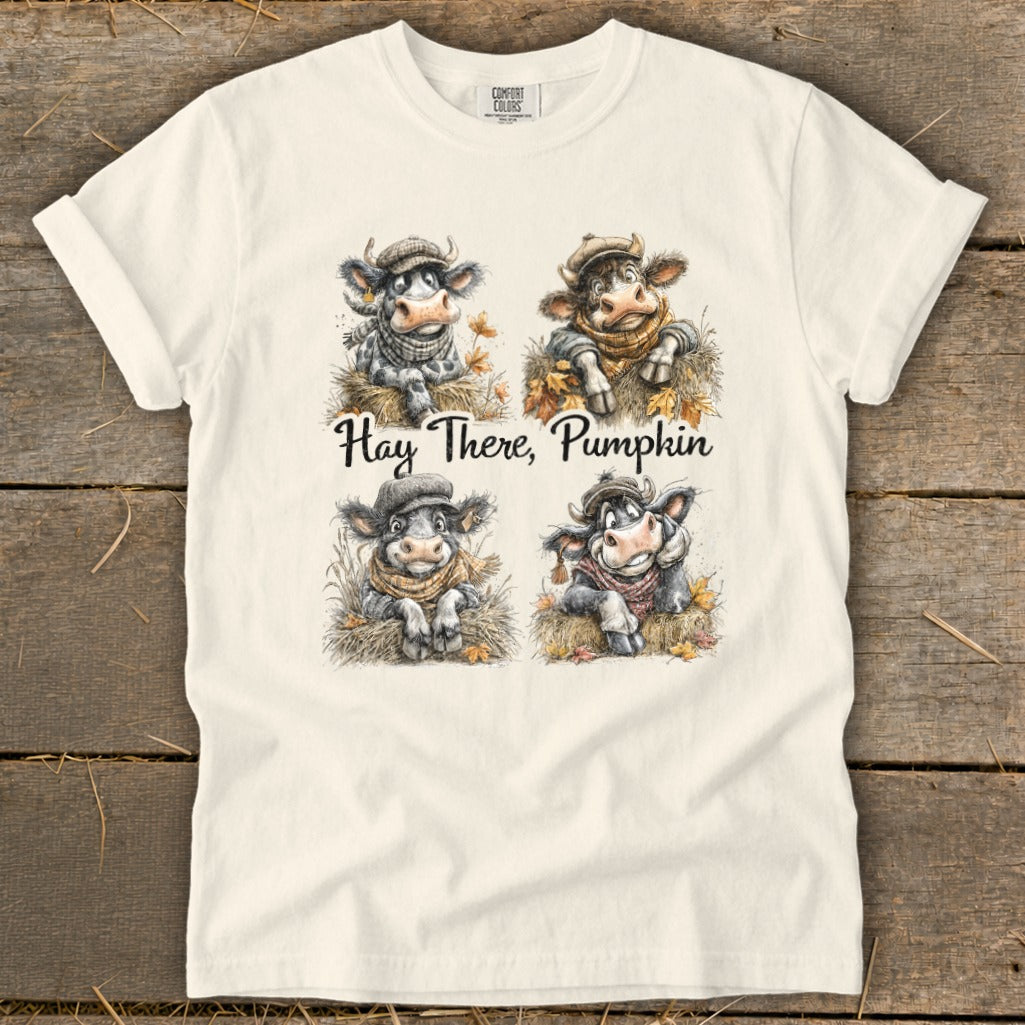 Four cute cows wearing scarves and hats with text "Hay There, Pumpkin".
