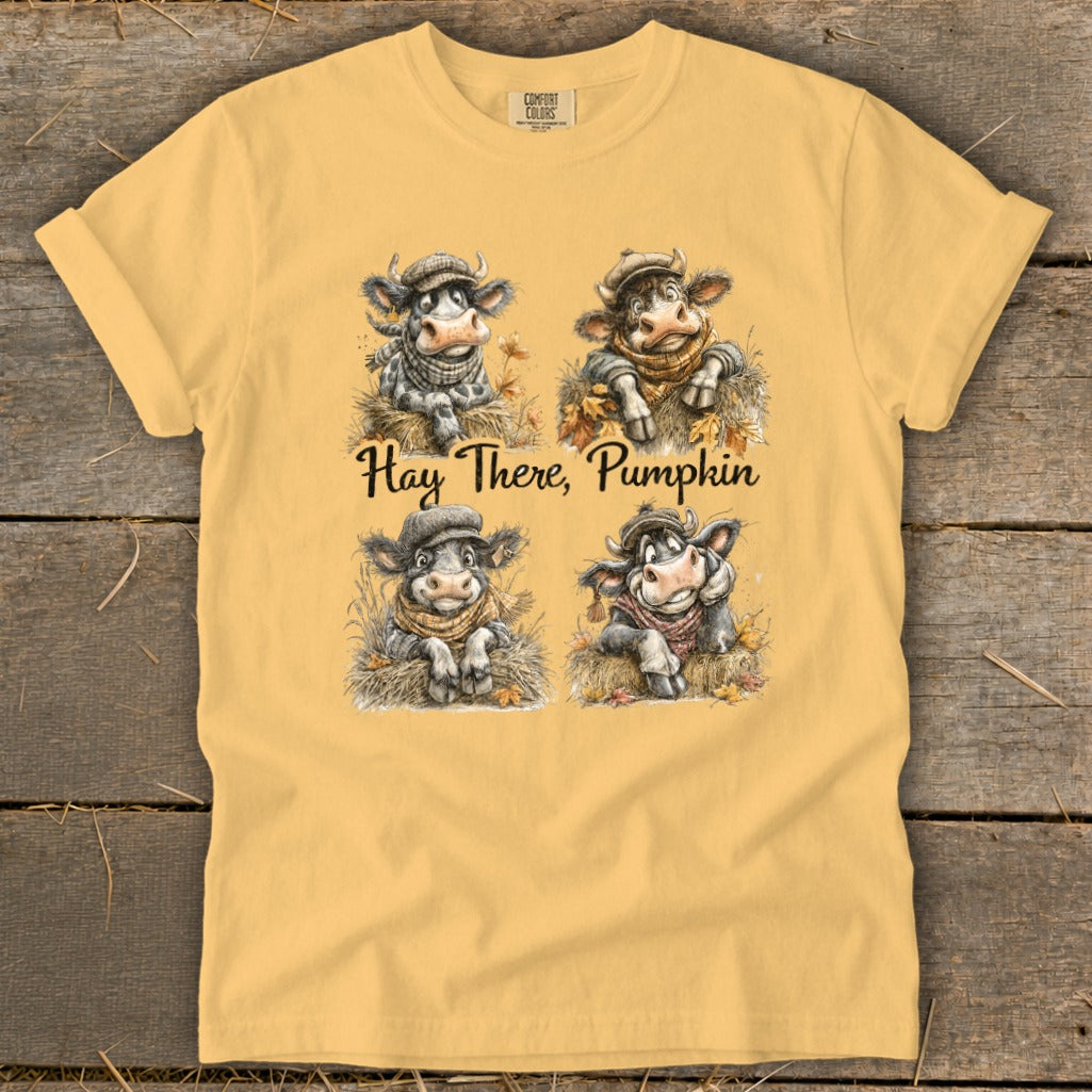 Yellow t-shirt with four cartoon cows and the text "Hay There, Pumpkin".