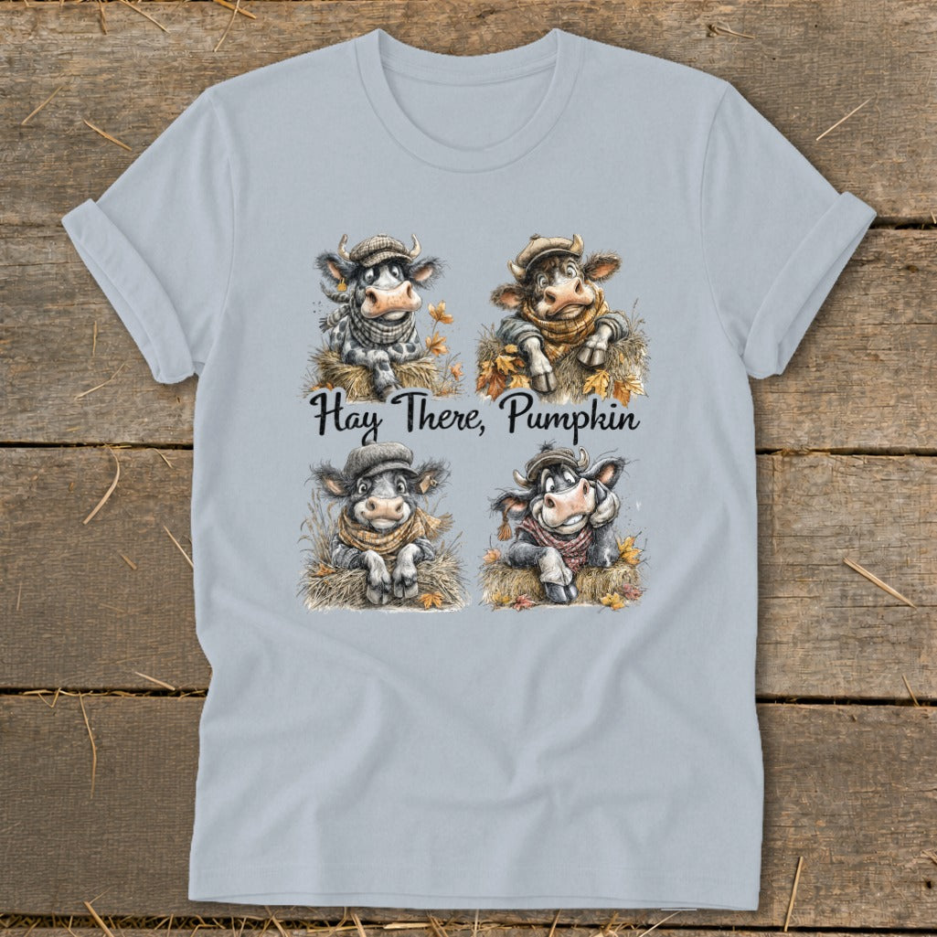 Four cartoon cows in hats and scarves on hay, with text "Hay There, Pumpkin".