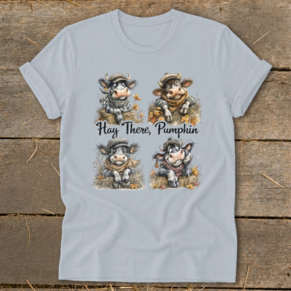 Four cartoon cows in hats and scarves on hay, with text "Hay There, Pumpkin".