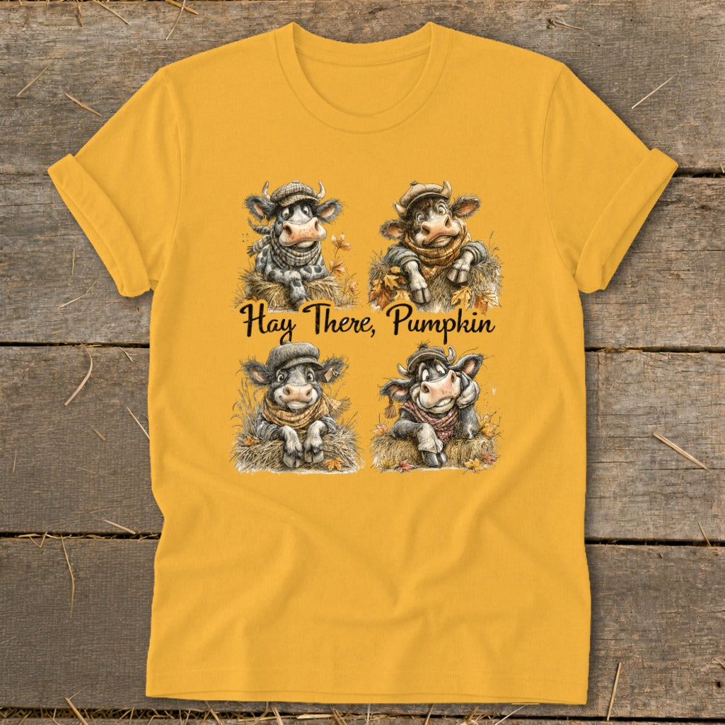 Four cows in hats and scarves sit in hay with text "Hay There, Pumpkin".