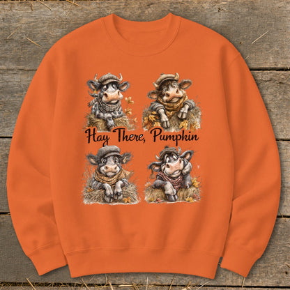 Four cartoon cows in autumn attire, with the text "Hay There, Pumpkin."