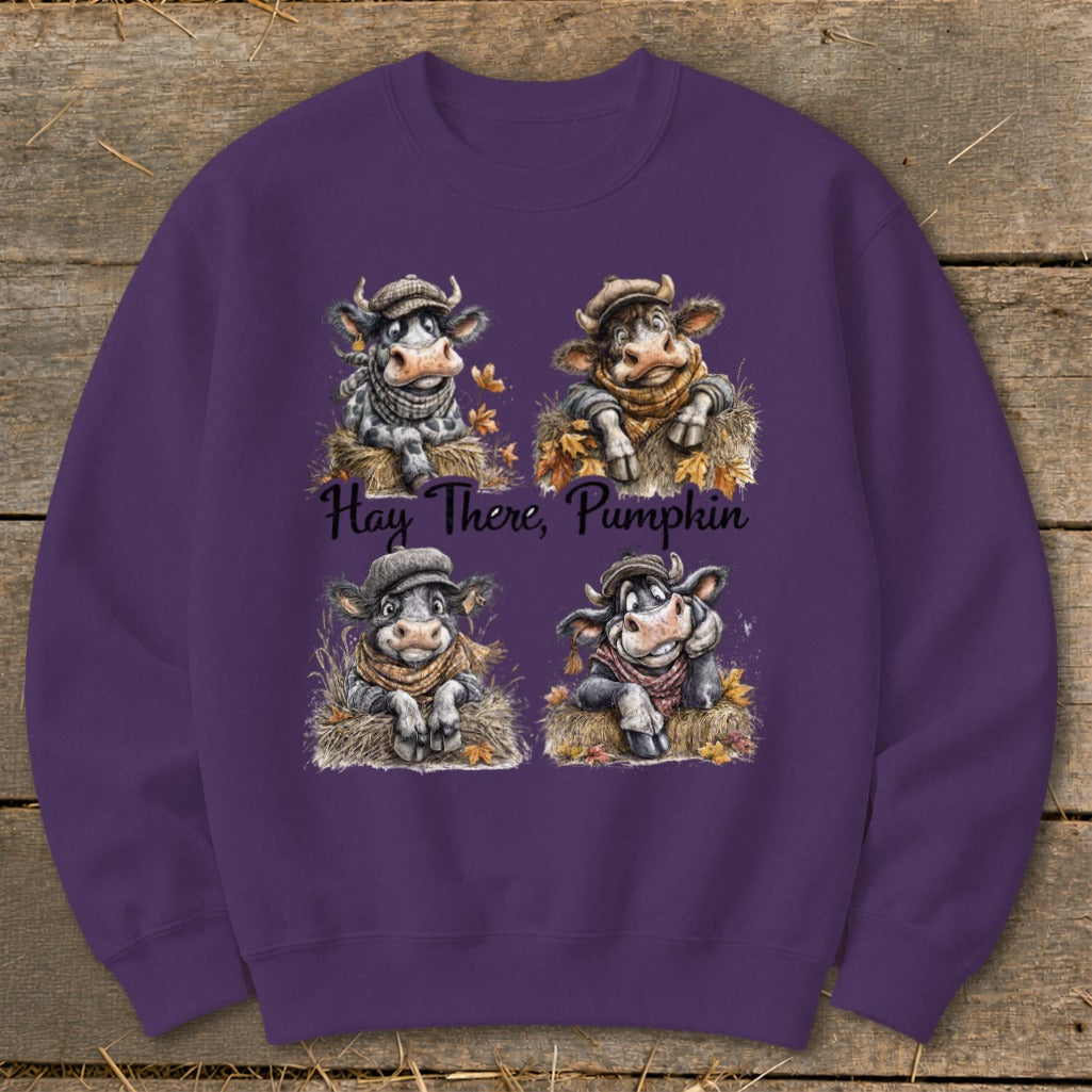 Four cartoon cows in hats and scarves sitting on hay, with text "Hay There, Pumpkin".