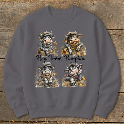 Four cartoon cows in hats and scarves with "Hay There, Pumpkin" text.