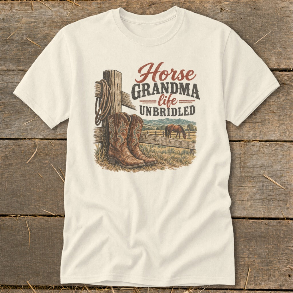 An off-white t-shirt featuring a western graphic with cowboy boots, a horse, and the text Horse Grandma Life Unbridled.