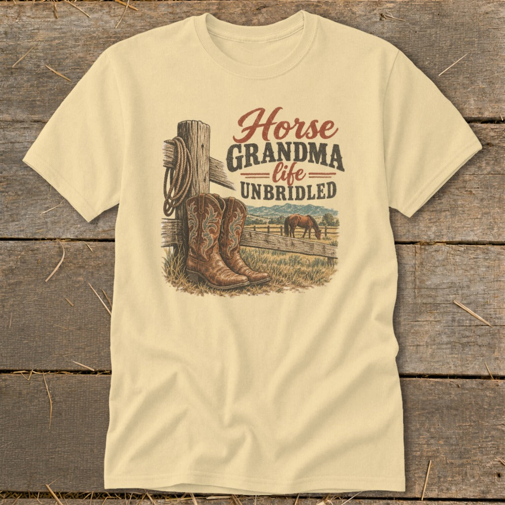 A light yellow t-shirt features a graphic with cowboy boots, a fence, a horse, and text.