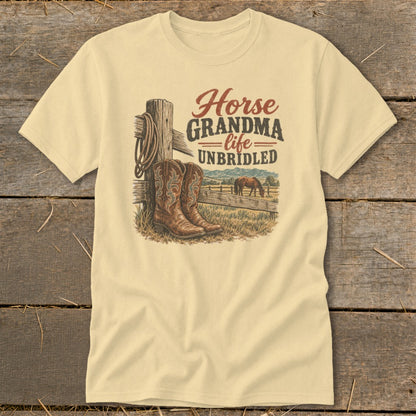 A light yellow t-shirt features a graphic with cowboy boots, a fence, a horse, and text.
