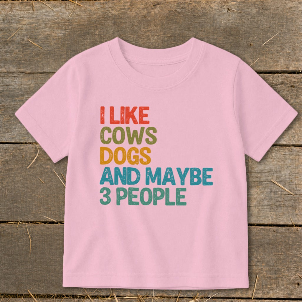 Pink t-shirt with text "I LIKE COWS DOGS AND MAYBE 3 PEOPLE"