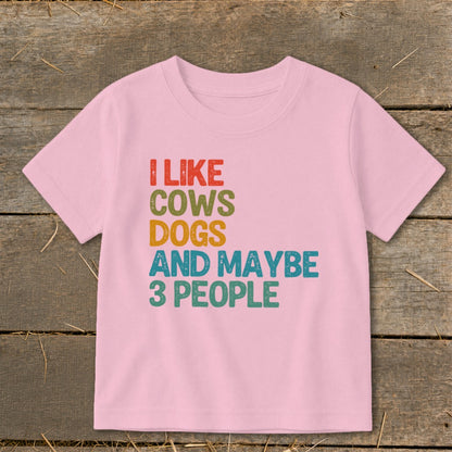 Pink t-shirt with text "I LIKE COWS DOGS AND MAYBE 3 PEOPLE"