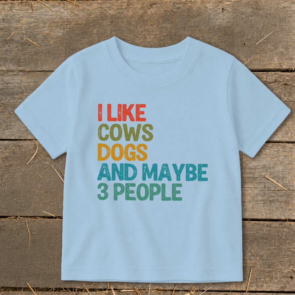 Light blue t-shirt with text "I LIKE COWS DOGS AND MAYBE 3 PEOPLE."