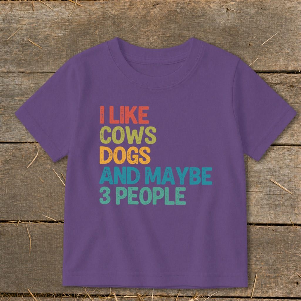 Purple t-shirt with text "I LIKE COWS DOGS AND MAYBE 3 PEOPLE".