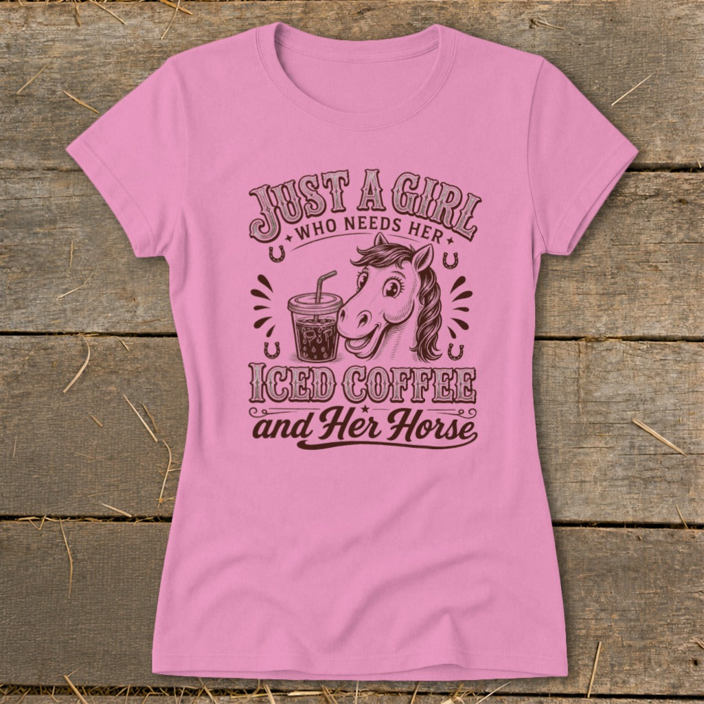 Pink women's t-shirt printed with a horse graphic, an iced coffee cup, and text reading Just A Girl Who Needs Her Iced Coffee and Her Horse.
