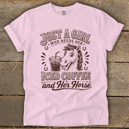 A light pink t-shirt featuring a cartoon horse, an iced coffee, and western-style text.