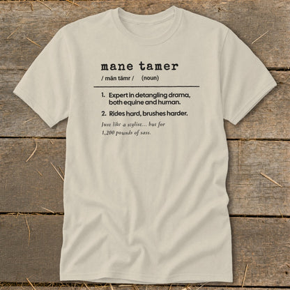 Light-colored t-shirt with "mane tamer" definition print.