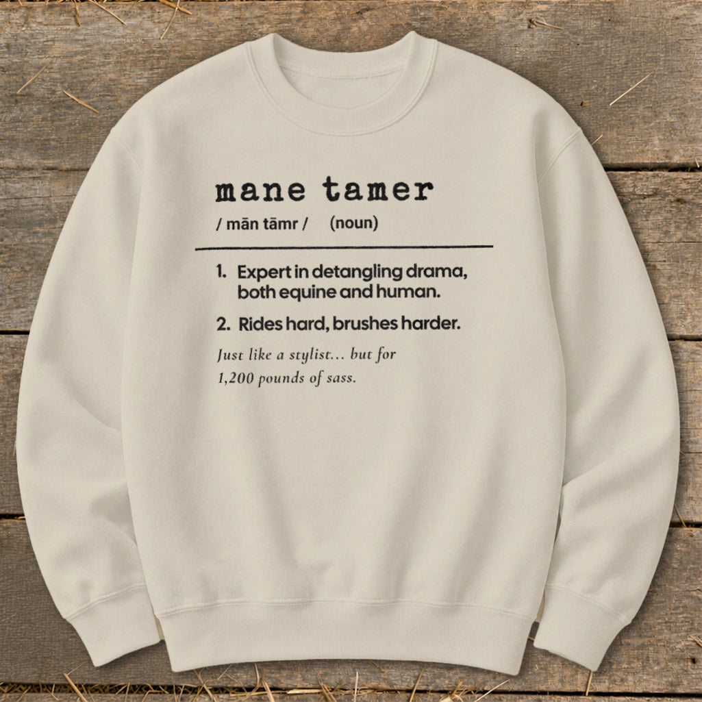 Cream sweatshirt with "mane tamer" definition, referencing equine and human drama.