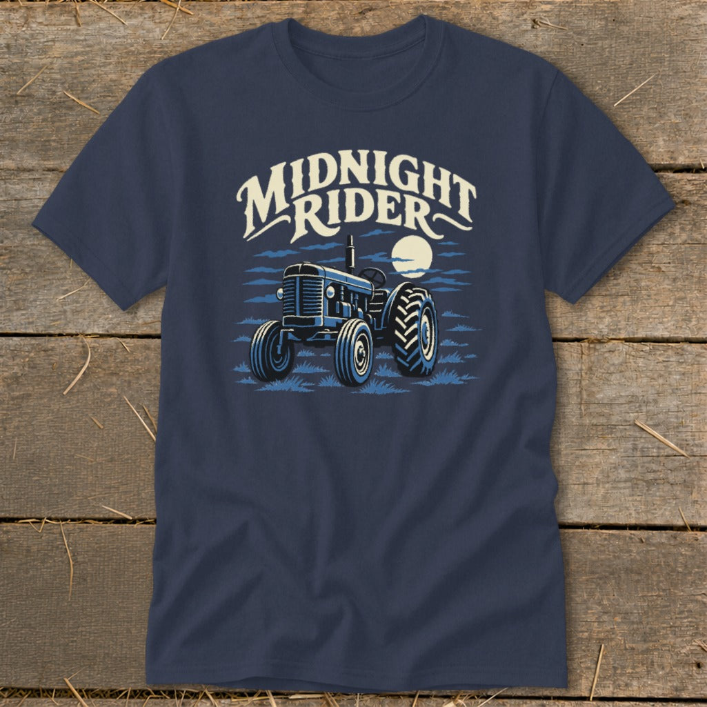 Navy blue t-shirt featuring a graphic of a vintage tractor under a full moon, with the text Midnight Rider above it.