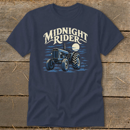 Navy blue t-shirt featuring a graphic of a vintage tractor under a full moon, with the text Midnight Rider above it.