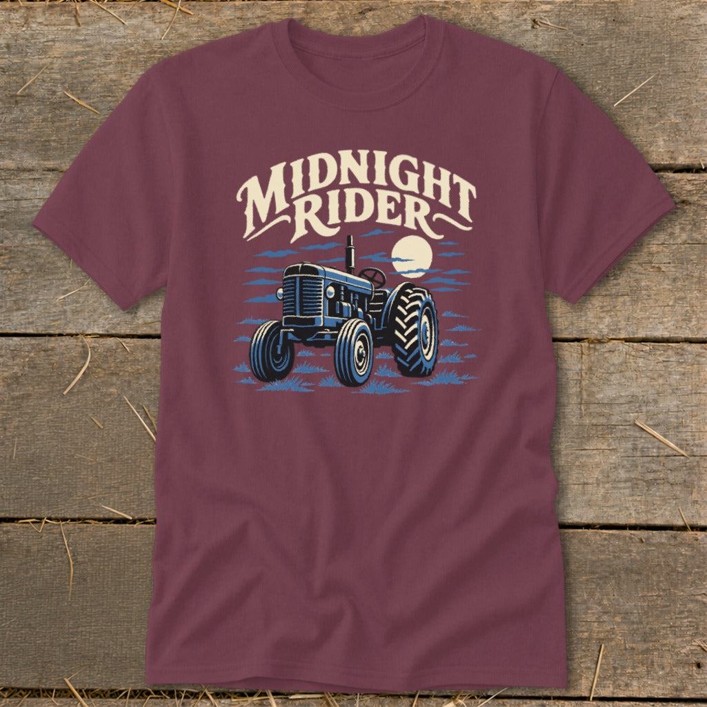 Maroon short-sleeved t-shirt featuring a blue tractor graphic and the text Midnight Rider.
