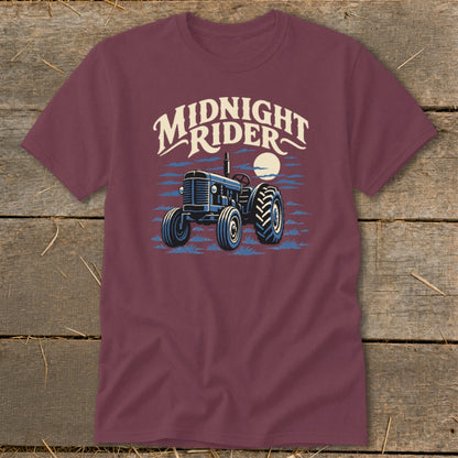Maroon short-sleeved t-shirt featuring a blue tractor graphic and the text Midnight Rider.