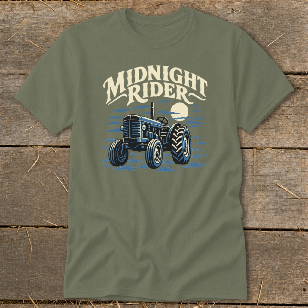 An olive green crewneck t-shirt featuring a graphic of a blue tractor with the text MIDNIGHT RIDER above it.