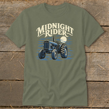 An olive green crewneck t-shirt featuring a graphic of a blue tractor with the text MIDNIGHT RIDER above it.