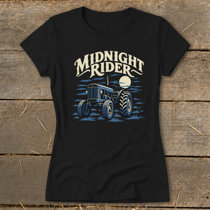 A black short-sleeved t-shirt featuring a blue tractor illustration, a moon, and the text Midnight Rider.