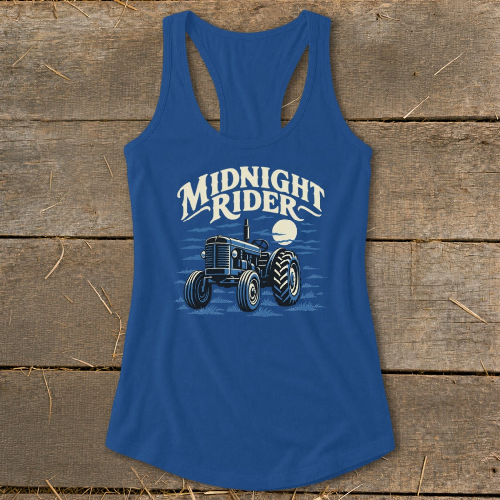 Royal blue women's racerback tank top featuring a graphic of a tractor under the moon and the text "Midnight Rider."