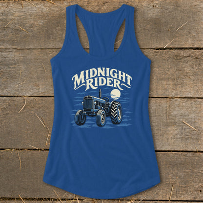 Royal blue women's racerback tank top featuring a graphic of a tractor under the moon and the text "Midnight Rider."