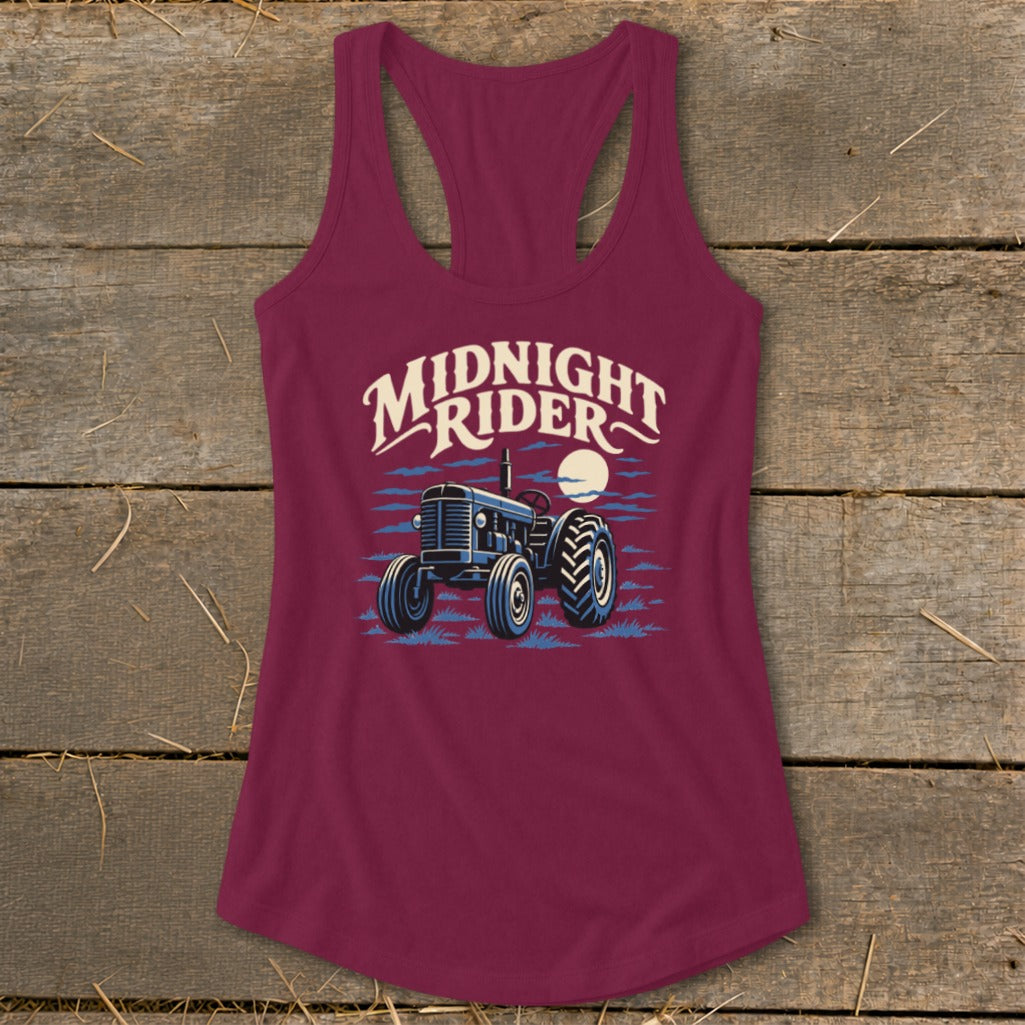 Maroon women's racerback tank top featuring a graphic of a tractor under the moon and Midnight Rider text.
