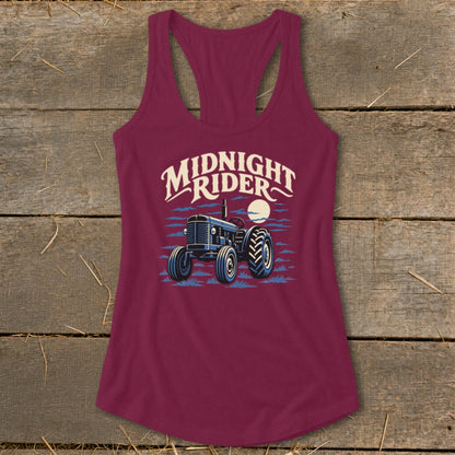 Maroon women's racerback tank top featuring a graphic of a tractor under the moon and Midnight Rider text.