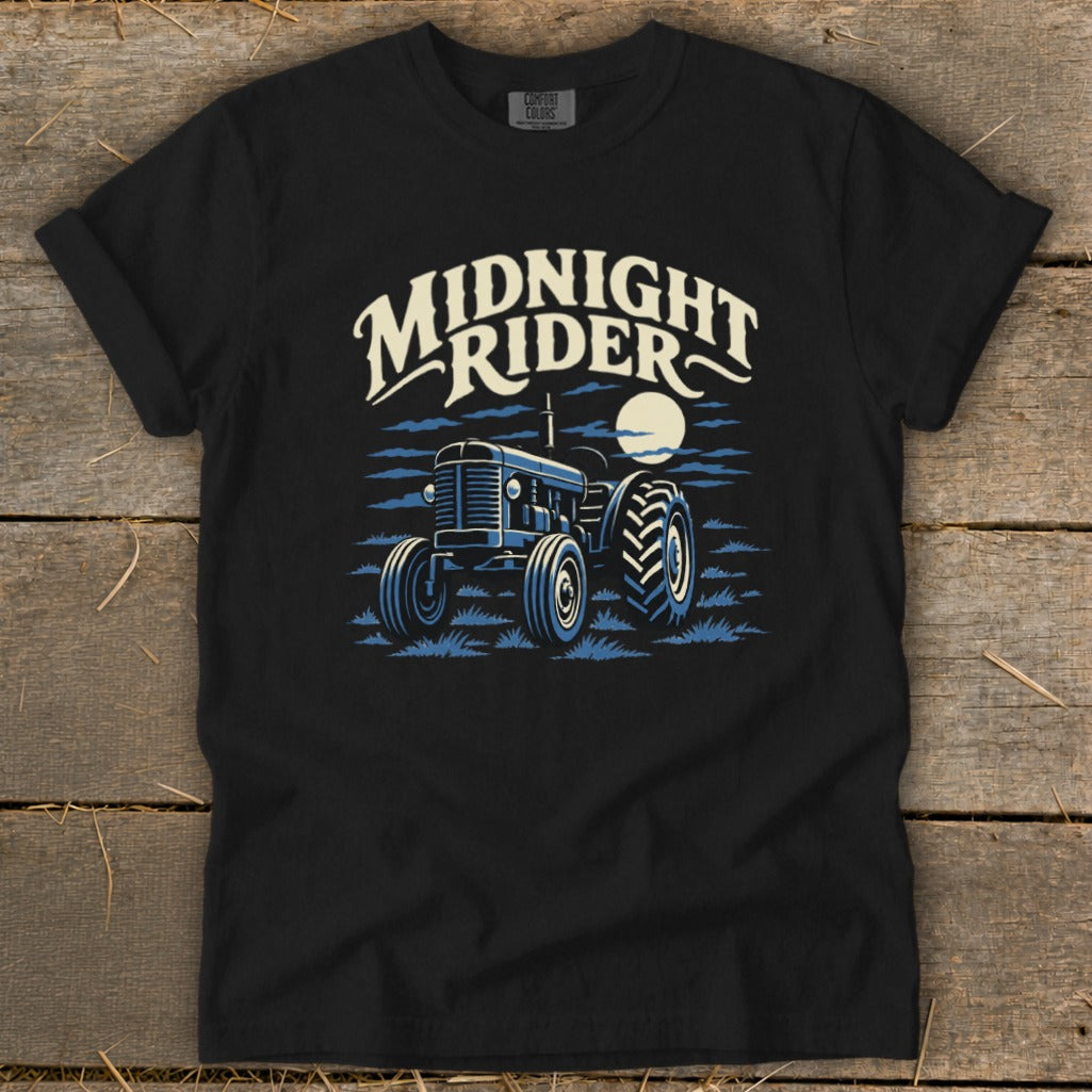 Black t-shirt featuring a blue graphic of a tractor under a moon and the text Midnight Rider.