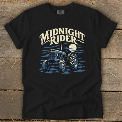 Black t-shirt featuring a blue graphic of a tractor under a moon and the text Midnight Rider.