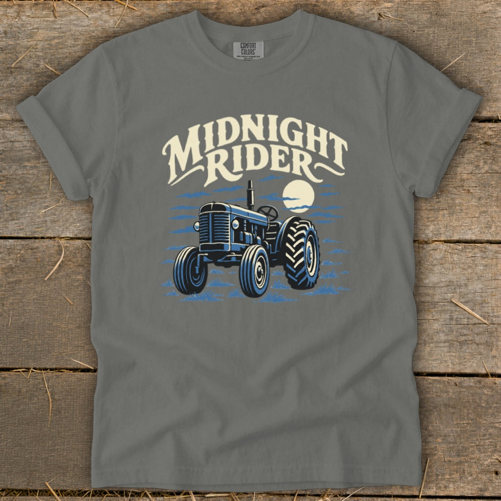Charcoal gray t-shirt featuring a graphic of a vintage tractor under a moon with the text Midnight Rider.