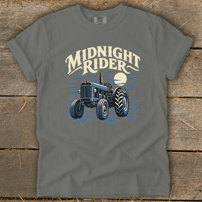 Charcoal gray t-shirt featuring a graphic of a vintage tractor under a moon with the text Midnight Rider.