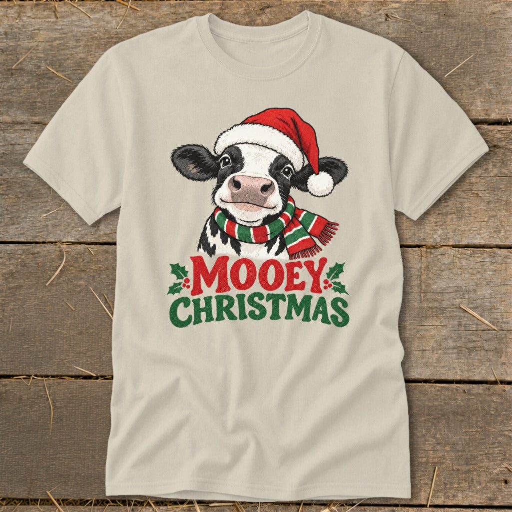 Light beige t-shirt with a cow wearing a Santa hat and scarf, saying "Mooey Christmas."