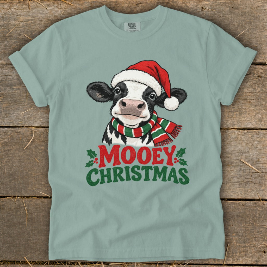 T-shirt with a cartoon cow wearing a Santa hat and striped scarf, text says "Mooey Christmas."