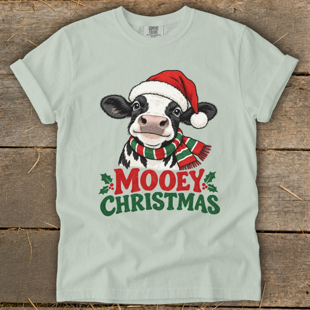 Cow in Santa hat and scarf with text "Mooey Christmas".