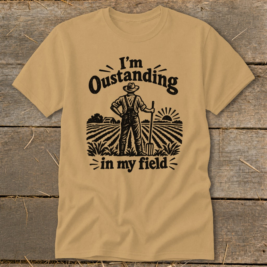 T-shirt with "I'm Oustanding in my field" graphic of a farmer in a field.