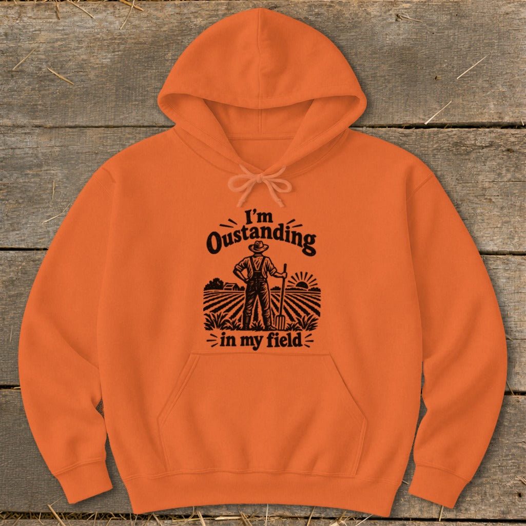 Orange hoodie with black text and graphic: "I'm Oustanding in my field."