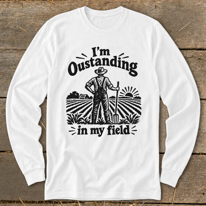 White long-sleeve shirt with "I'm Outstanding in my Field" farmer graphic.