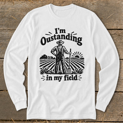 White long-sleeve shirt with graphic "I'm Oustanding in my field" and farmer.