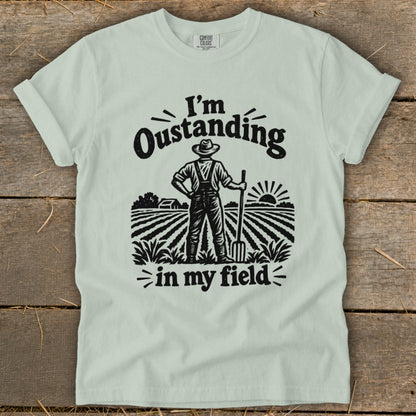 Farmer with pitchfork in a field, text "I'm Oustanding in my field".