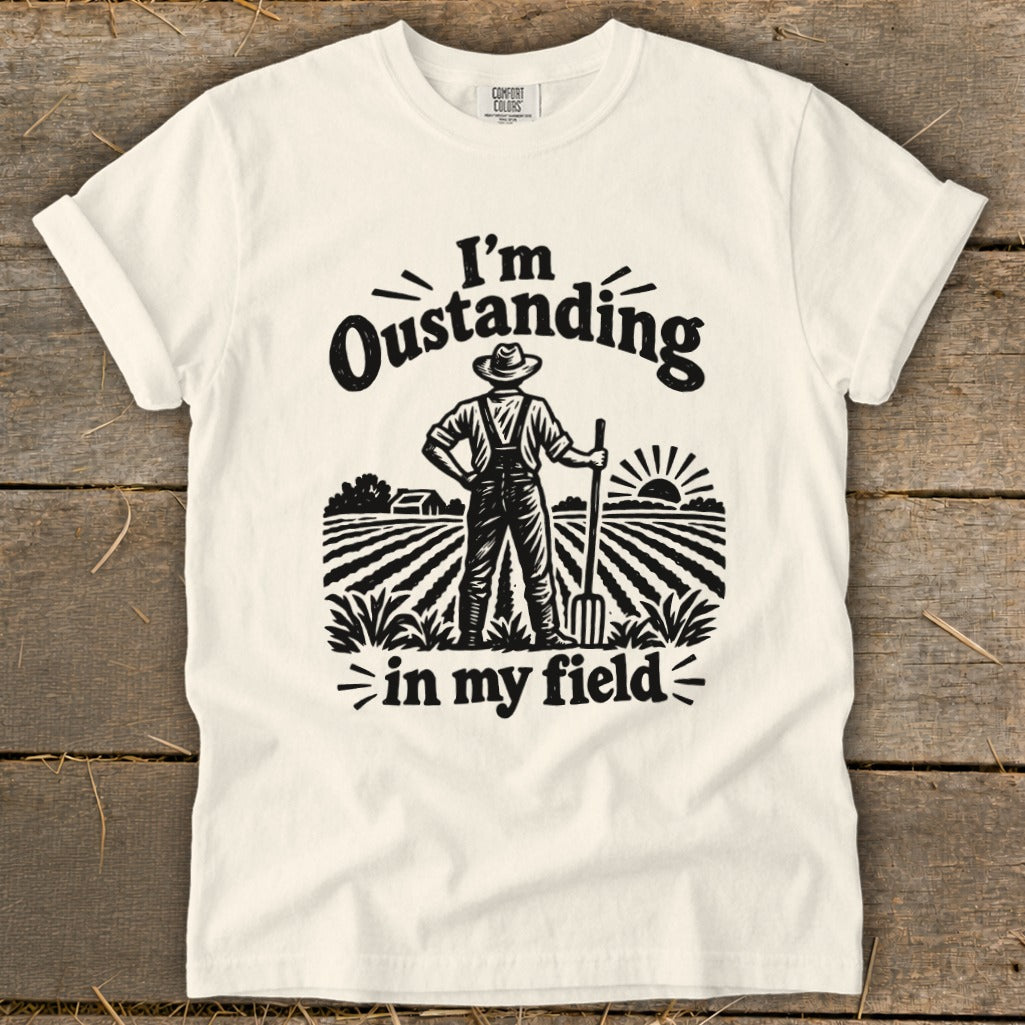 T-shirt with "I'm Outstanding in my Field" graphic of farmer in a field.