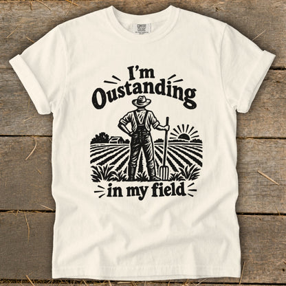 T-shirt with "I'm Outstanding in my Field" graphic of farmer in a field.