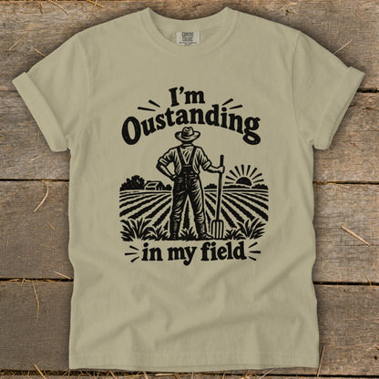T-shirt with text "I'm Oustanding in my field" and farmer illustration.