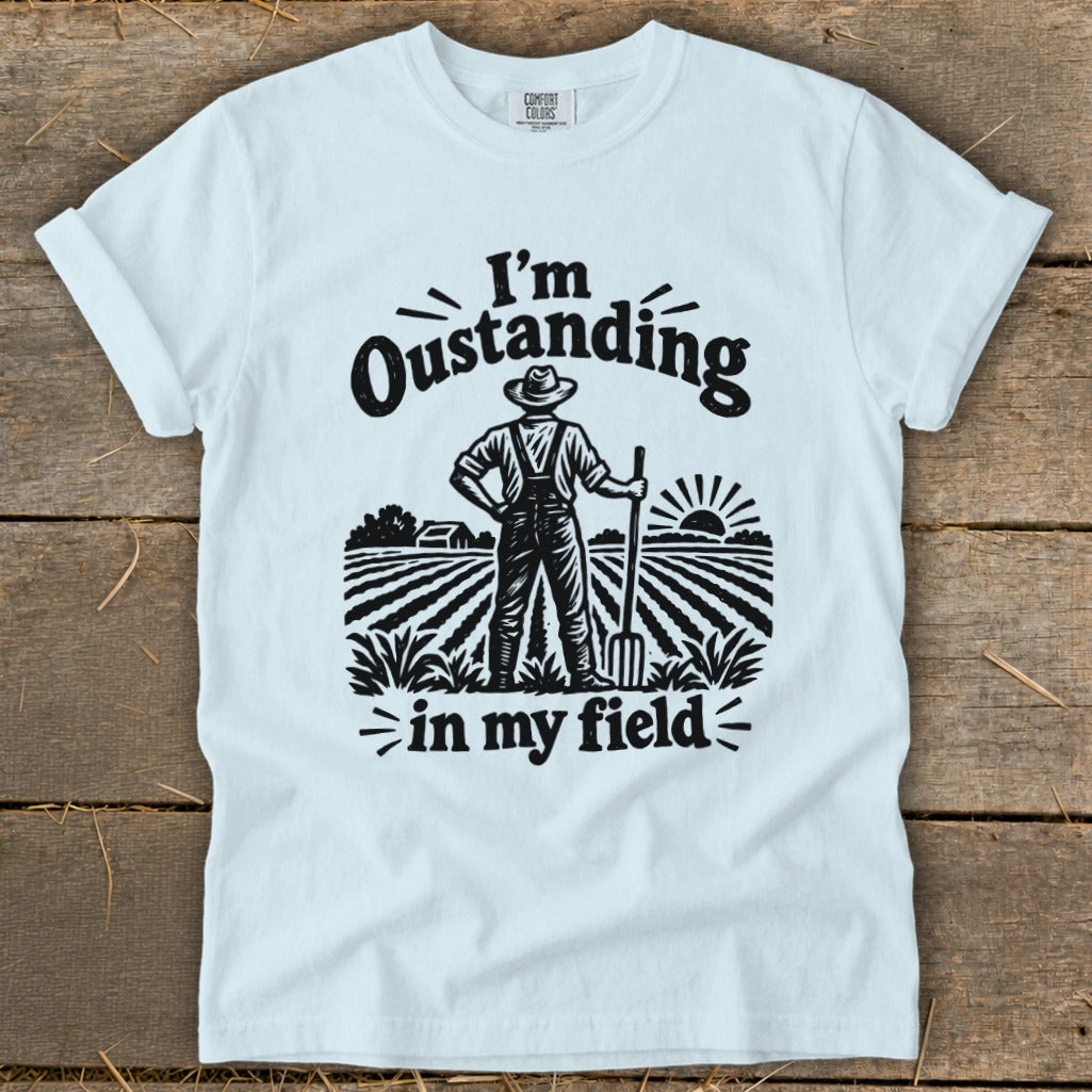 White t-shirt with "I'm Oustanding in my field" graphic of a farmer.