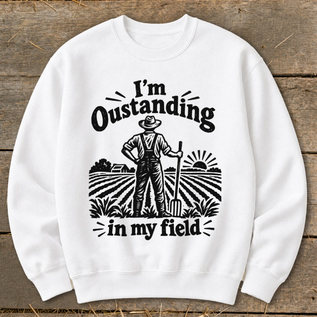 White sweatshirt with graphic "I'm Oustanding in my field" and farmer illustration.